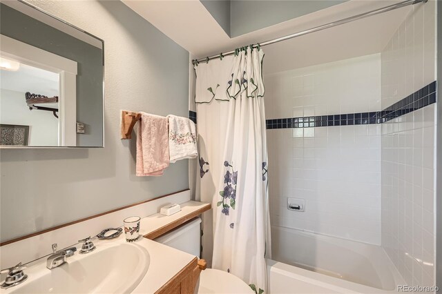 bathroom with toilet, shower / bath combo, and vanity