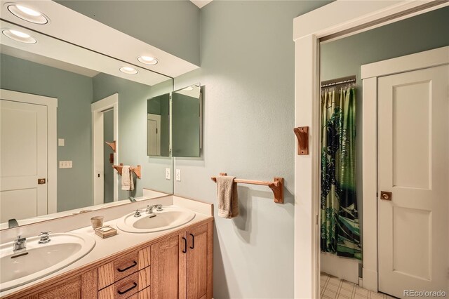 full bathroom with recessed lighting, double vanity, and tile patterned floors
