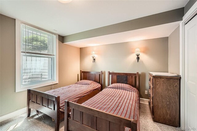 bedroom with carpet flooring and baseboards