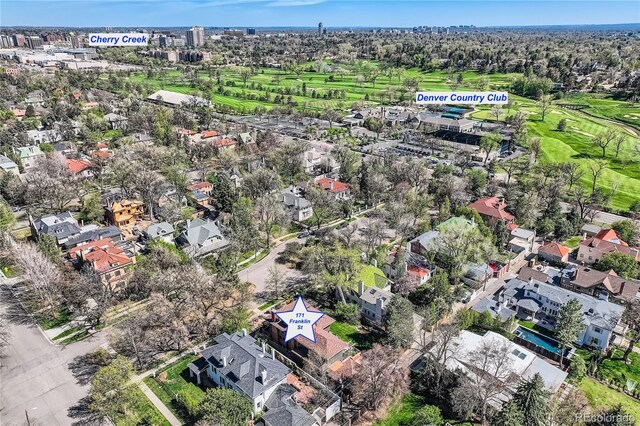 aerial view of property's location with nearby suburban area and a local golf course