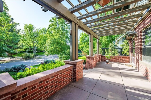 view of patio featuring a pergola and a porch