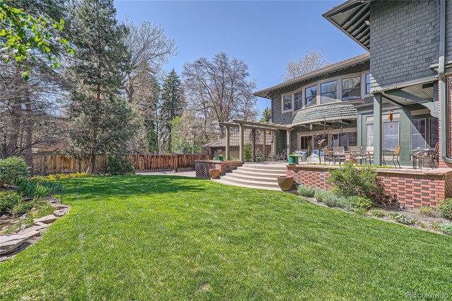 view of yard featuring a patio area and a fenced backyard
