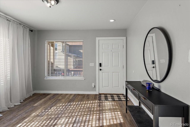 foyer featuring baseboards, wood finished floors, and recessed lighting