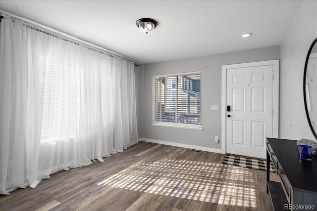 entrance foyer featuring baseboards, wood finished floors, and recessed lighting