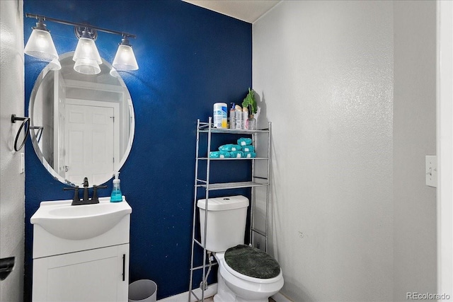 half bath featuring toilet and vanity