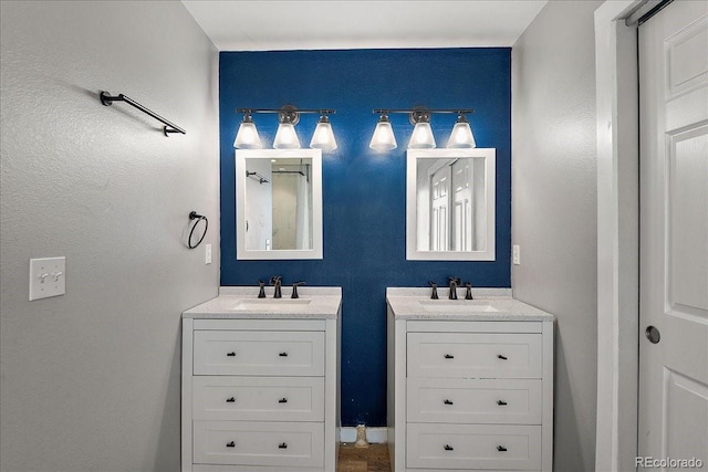 full bathroom with two vanities and a sink