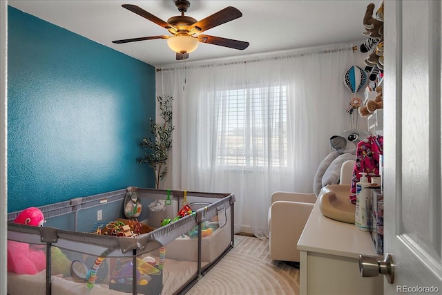 bedroom featuring ceiling fan and a textured wall