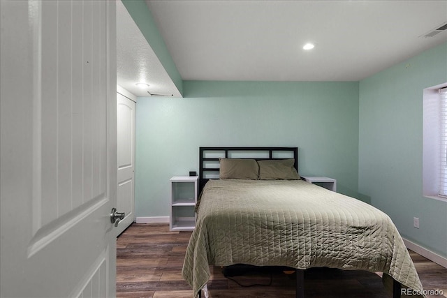 bedroom featuring baseboards, visible vents, wood finished floors, and recessed lighting