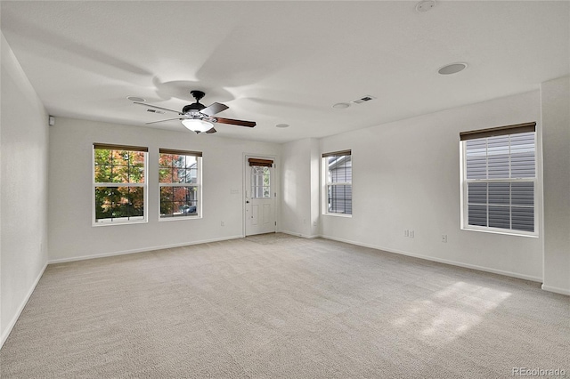 carpeted spare room with ceiling fan