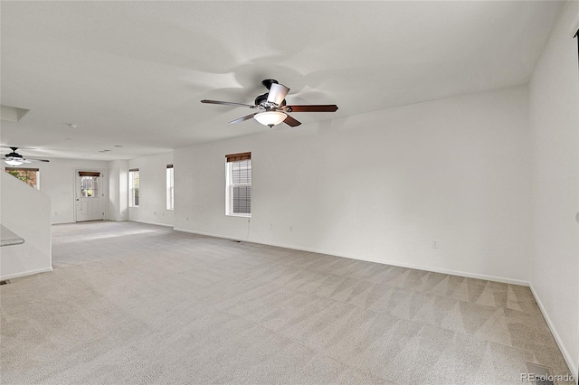 carpeted spare room with ceiling fan