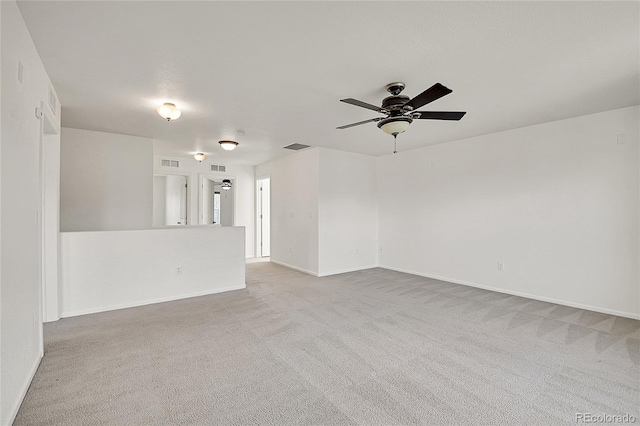 spare room with light carpet and ceiling fan