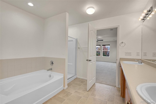 bathroom featuring ceiling fan, separate shower and tub, and vanity