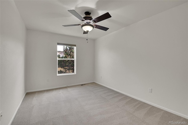 carpeted spare room with ceiling fan