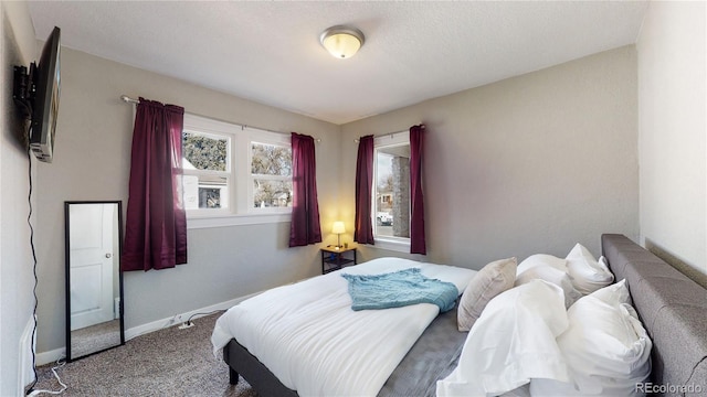 bedroom featuring carpet floors and baseboards