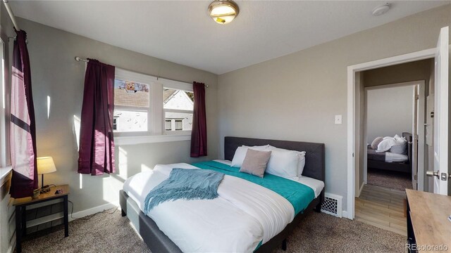 carpeted bedroom with baseboards and visible vents