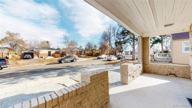 view of patio featuring a residential view and fence