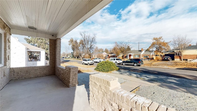 view of road with a residential view, curbs, and sidewalks