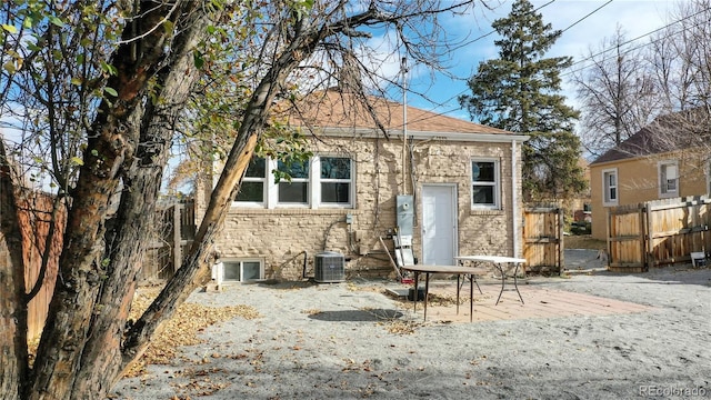 back of house with fence, central AC unit, and a patio