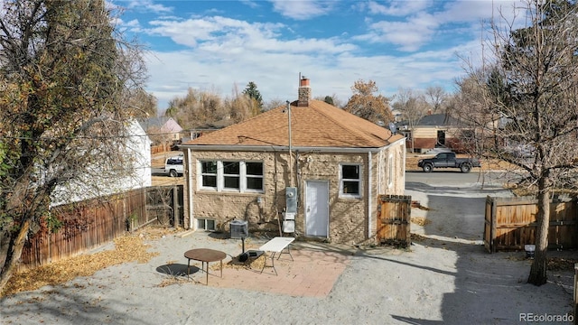 view of outbuilding with central AC and fence private yard