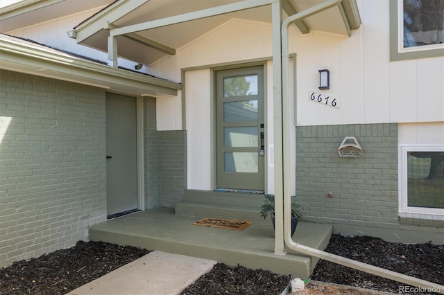 view of exterior entry with brick siding