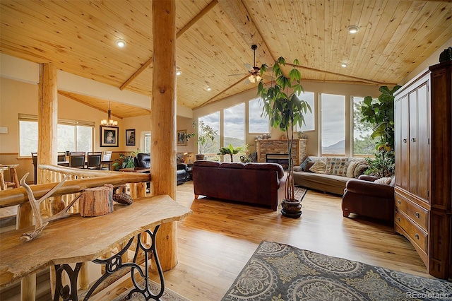 114 Star Ln, Bailey, CO 80421 - living area with light wood-type flooring, wood ceiling, a chandelier, recessed lighting, and a glass covered fireplace