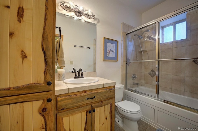 114 Star Ln, Bailey, CO 80421 - bathroom with toilet, vanity, bath / shower combo with glass door, and tile patterned floors