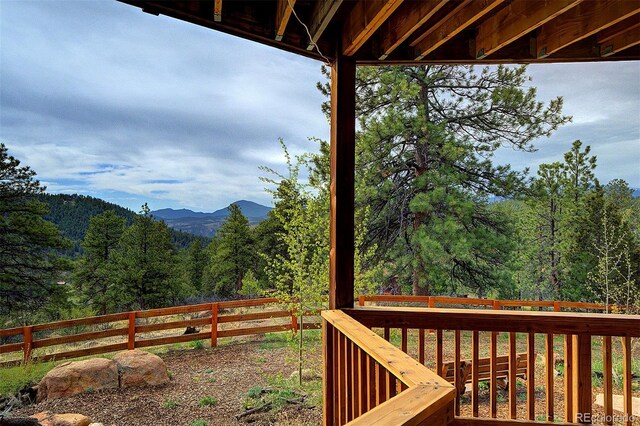 114 Star Ln, Bailey, CO 80421 - wooden deck with a view of trees, a fenced backyard, and a mountain view