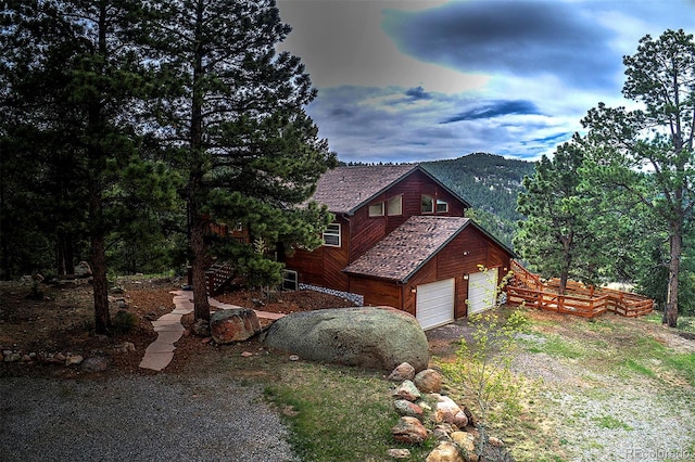 114 Star Ln, Bailey, CO 80421 - view of side of home with dirt driveway, a garage, and a mountain view