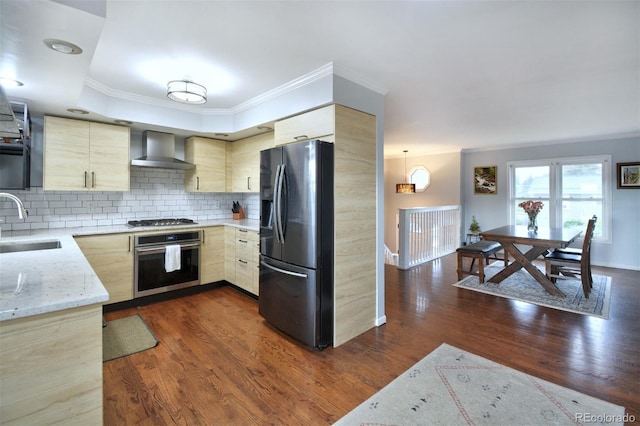 103 Aurelia St, Palmer Lake, CO 80133 - kitchen featuring appliances with stainless steel finishes, wall chimney exhaust hood, light brown cabinetry, crown molding, and tasteful backsplash