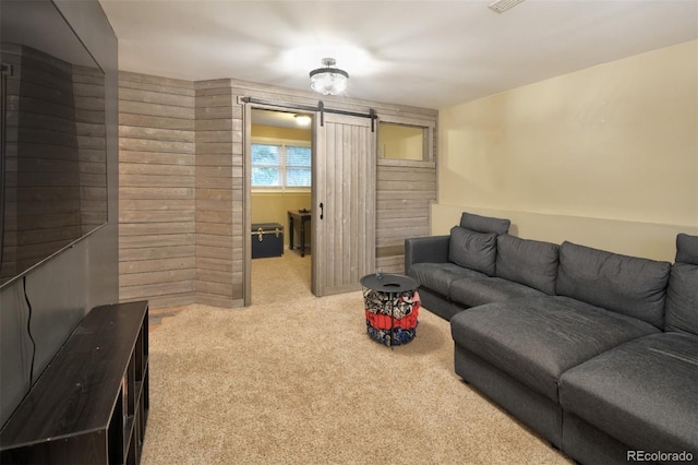 103 Aurelia St, Palmer Lake, CO 80133 - carpeted living room with a barn door and wooden walls
