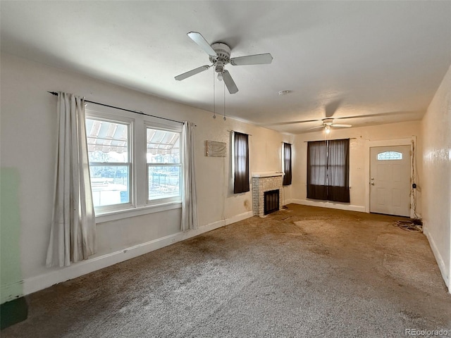 unfurnished living room featuring a fireplace, carpet flooring, a ceiling fan, and baseboards