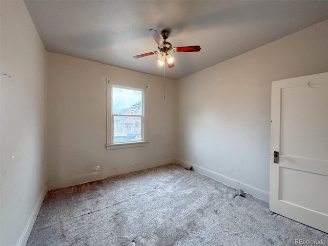 carpeted empty room with baseboards and ceiling fan