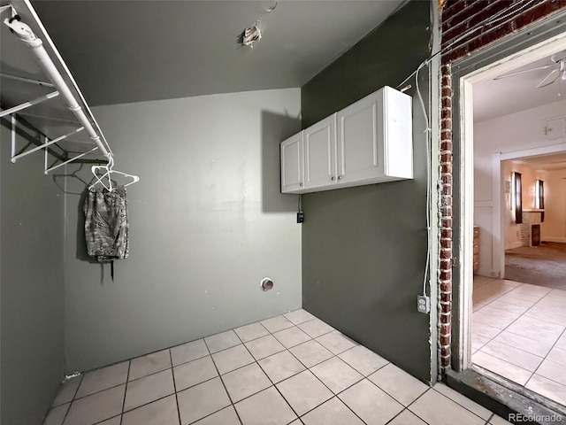 washroom featuring light tile patterned floors and cabinet space