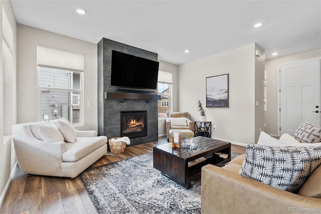 138 Lullaby Ln, Castle Rock, CO 80109 - living room with wood finished floors, a large fireplace, recessed lighting, and baseboards
