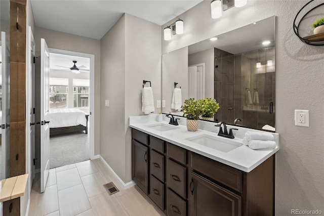 138 Lullaby Ln, Castle Rock, CO 80109 - bathroom featuring ceiling fan, a shower stall, tile patterned flooring, double vanity, and ensuite bath
