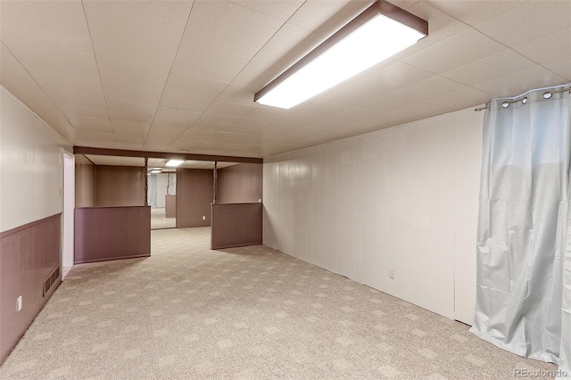 finished below grade area with light carpet and wood walls