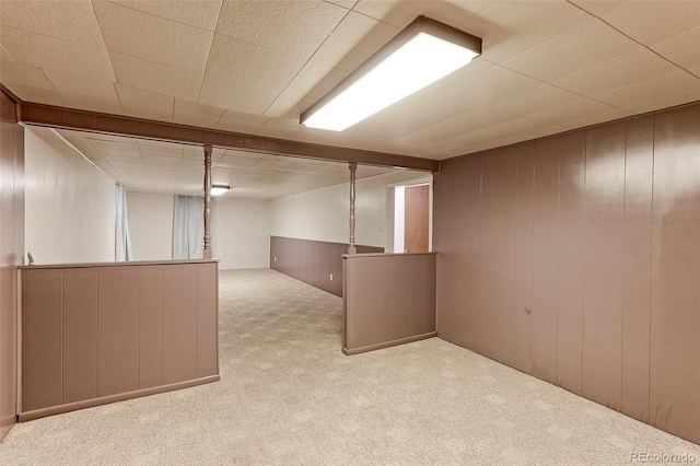 finished basement with carpet floors and wooden walls