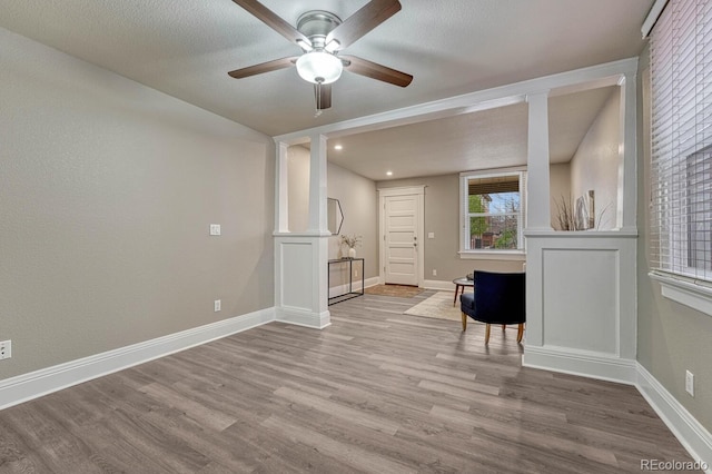 spare room featuring baseboards, a ceiling fan, and wood finished floors