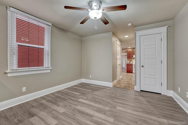 spare room featuring baseboards, recessed lighting, ceiling fan, and wood finished floors