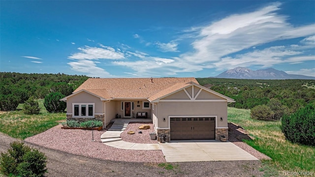 ranch-style house featuring a garage and a mountain view