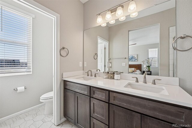 2449 Foerster Grass Vw, Colorado Springs, CO 80915 - bathroom with ensuite bath, a sink, double vanity, and toilet