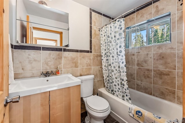 full bathroom featuring shower / bath combination with curtain, vanity, toilet, and tile walls