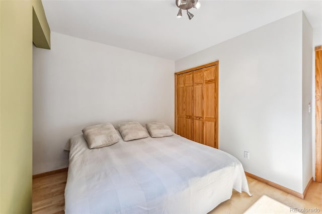 bedroom featuring a closet and light wood-type flooring