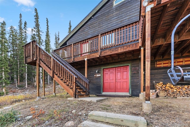 view of exterior entry with a wooden deck