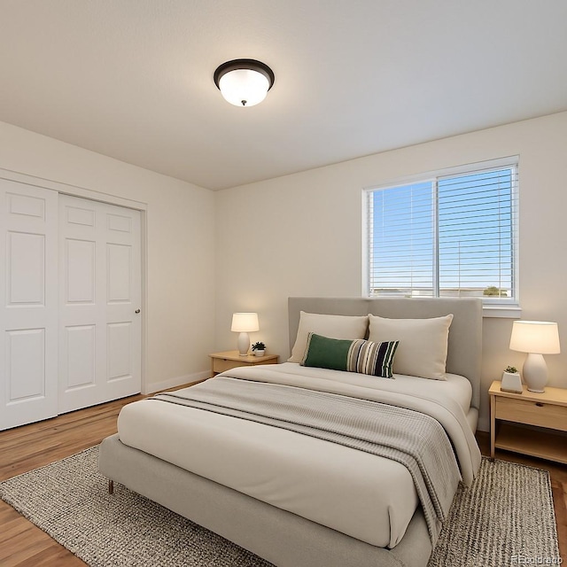 bedroom with baseboards, a closet, and wood finished floors