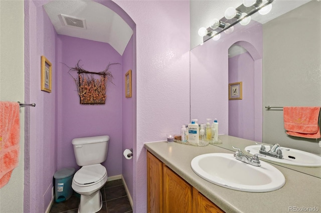 bathroom featuring visible vents, toilet, tile patterned floors, and vanity