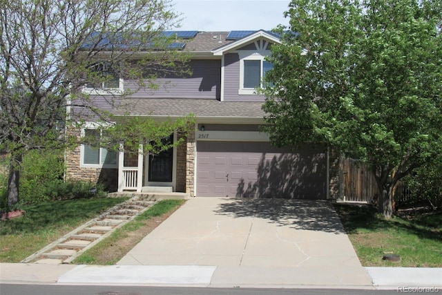 2517 S Genoa St, Aurora, CO 80013 - view of front of house with stone siding, concrete driveway, solar panels, and a garage