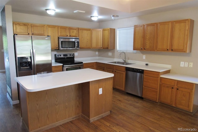 2517 S Genoa St, Aurora, CO 80013 - kitchen featuring appliances with stainless steel finishes, a sink, dark wood-type flooring, a center island, and light countertops