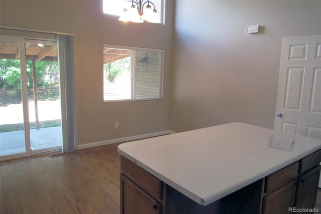 2517 S Genoa St, Aurora, CO 80013 - kitchen with a chandelier, plenty of natural light, wood finished floors, and light countertops