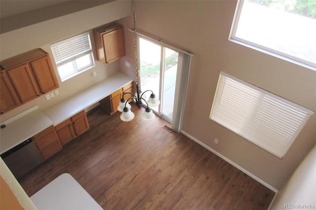2517 S Genoa St, Aurora, CO 80013 - kitchen with brown cabinets, dark wood finished floors, plenty of natural light, and light countertops